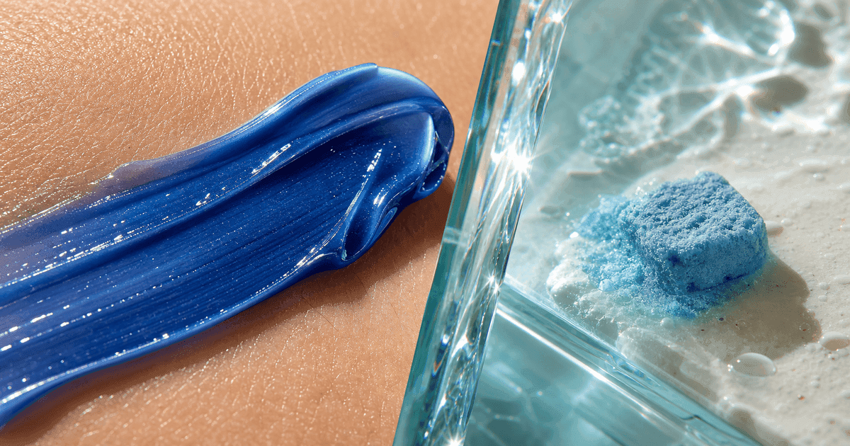 Cobalt cream contacting skin beside a dissolving blue oral square behind refracted glass