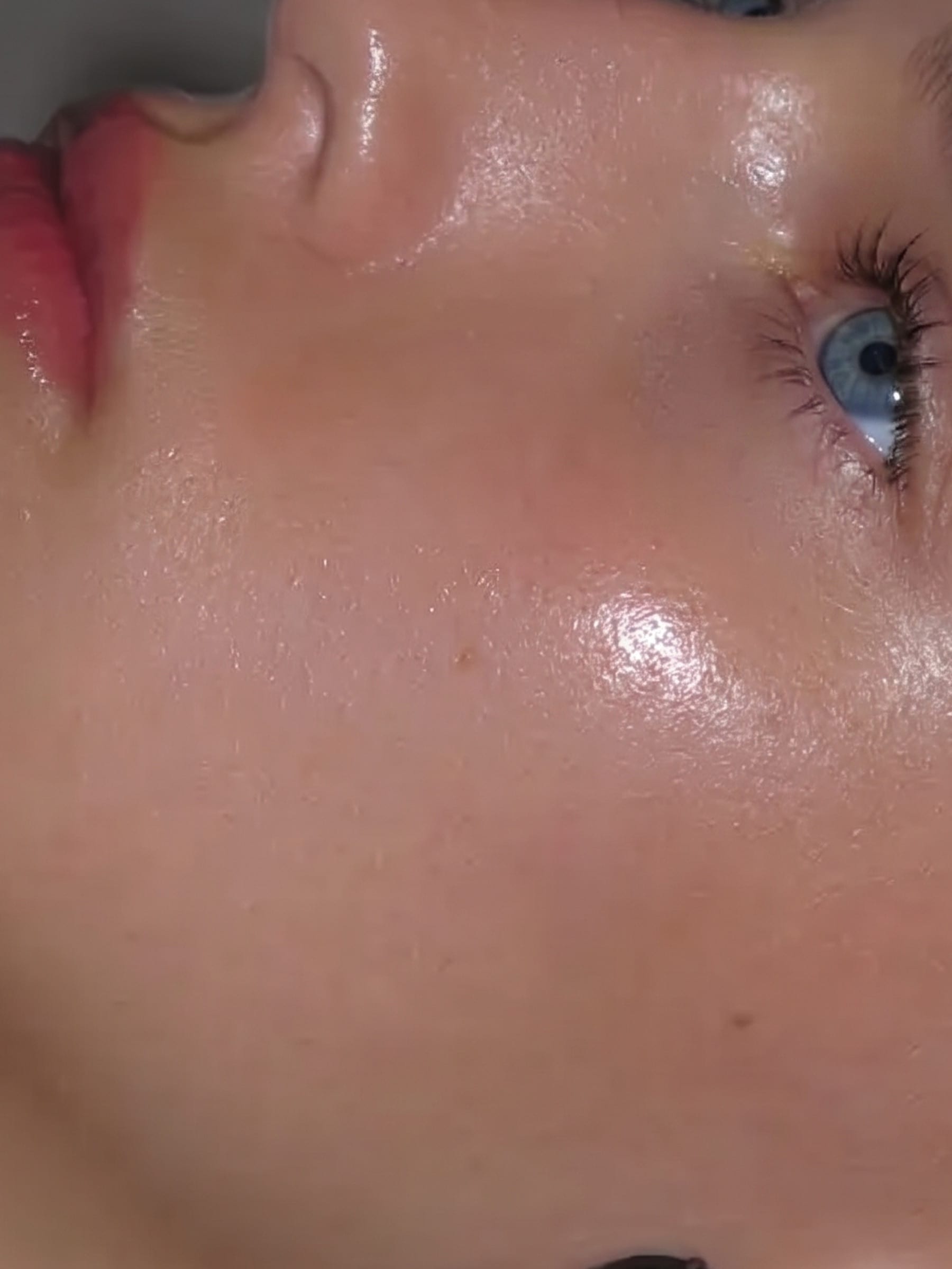 Extreme macro of lit skin across a cheekbone and eye.