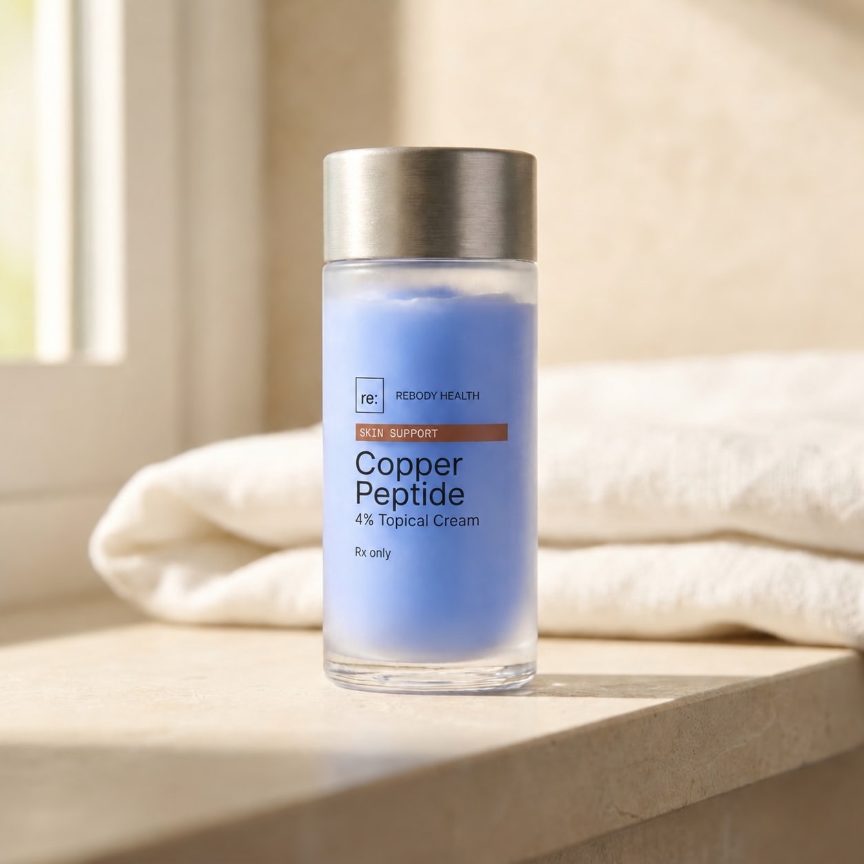 The Copper Peptide Cream 4% jar on a stone bathroom shelf beside a folded towel.