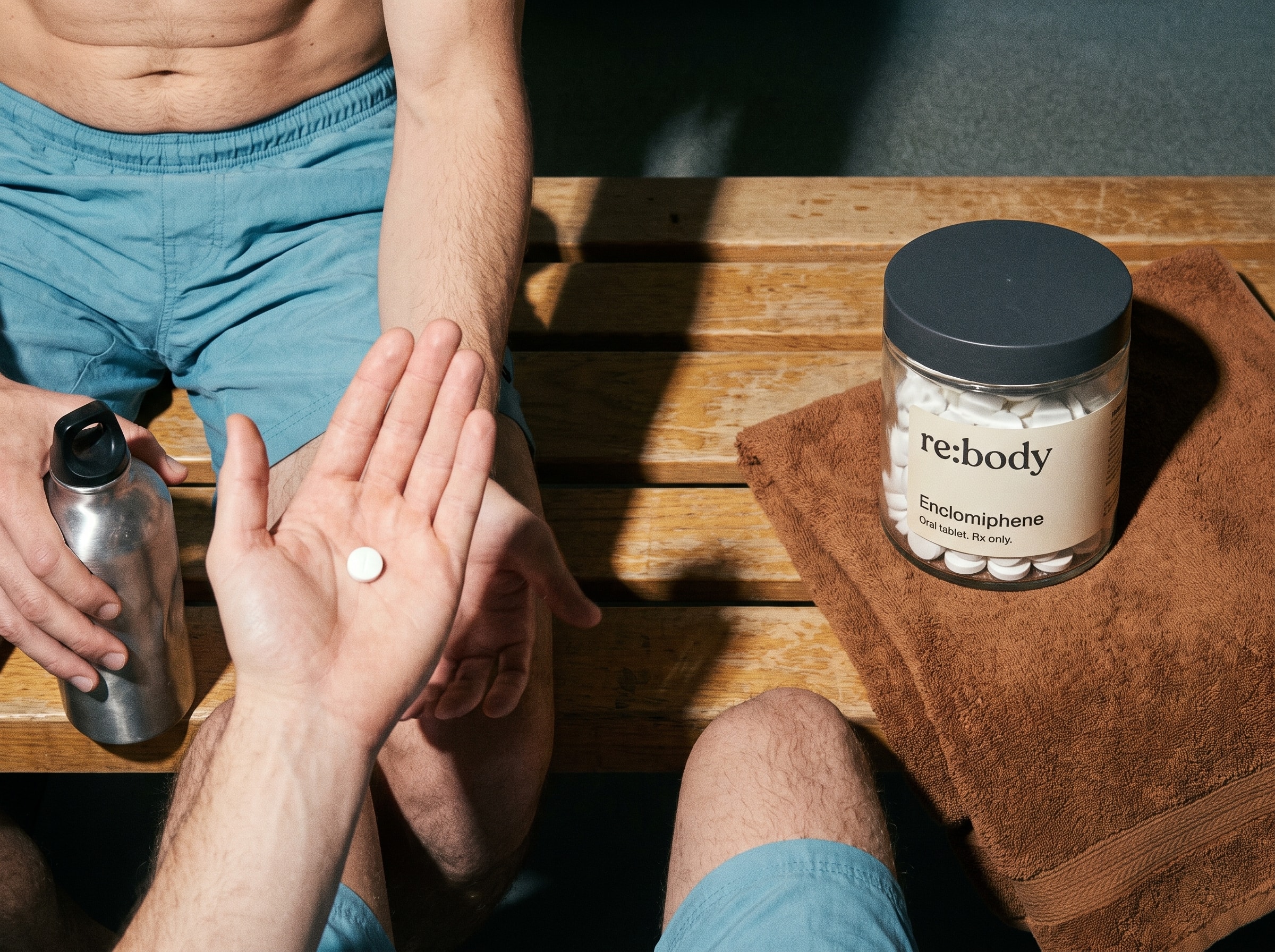 Enclomiphene tablet in an open palm beside the Rebody jar.