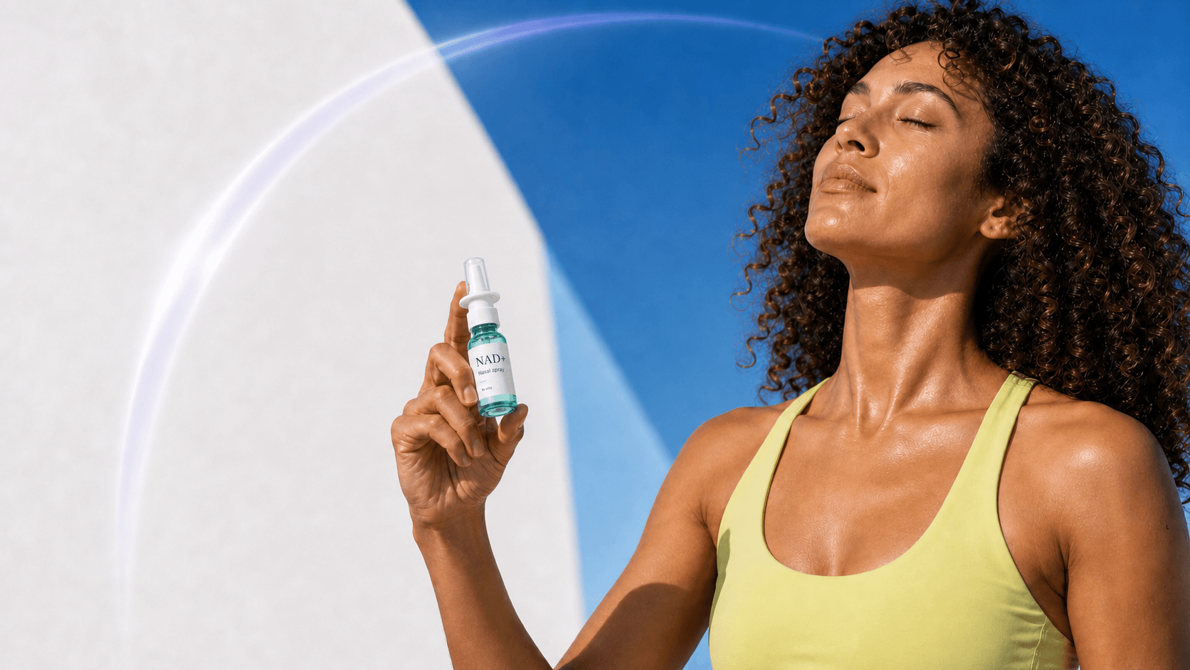 Woman holding an NAD+ nasal spray bottle against a blue background