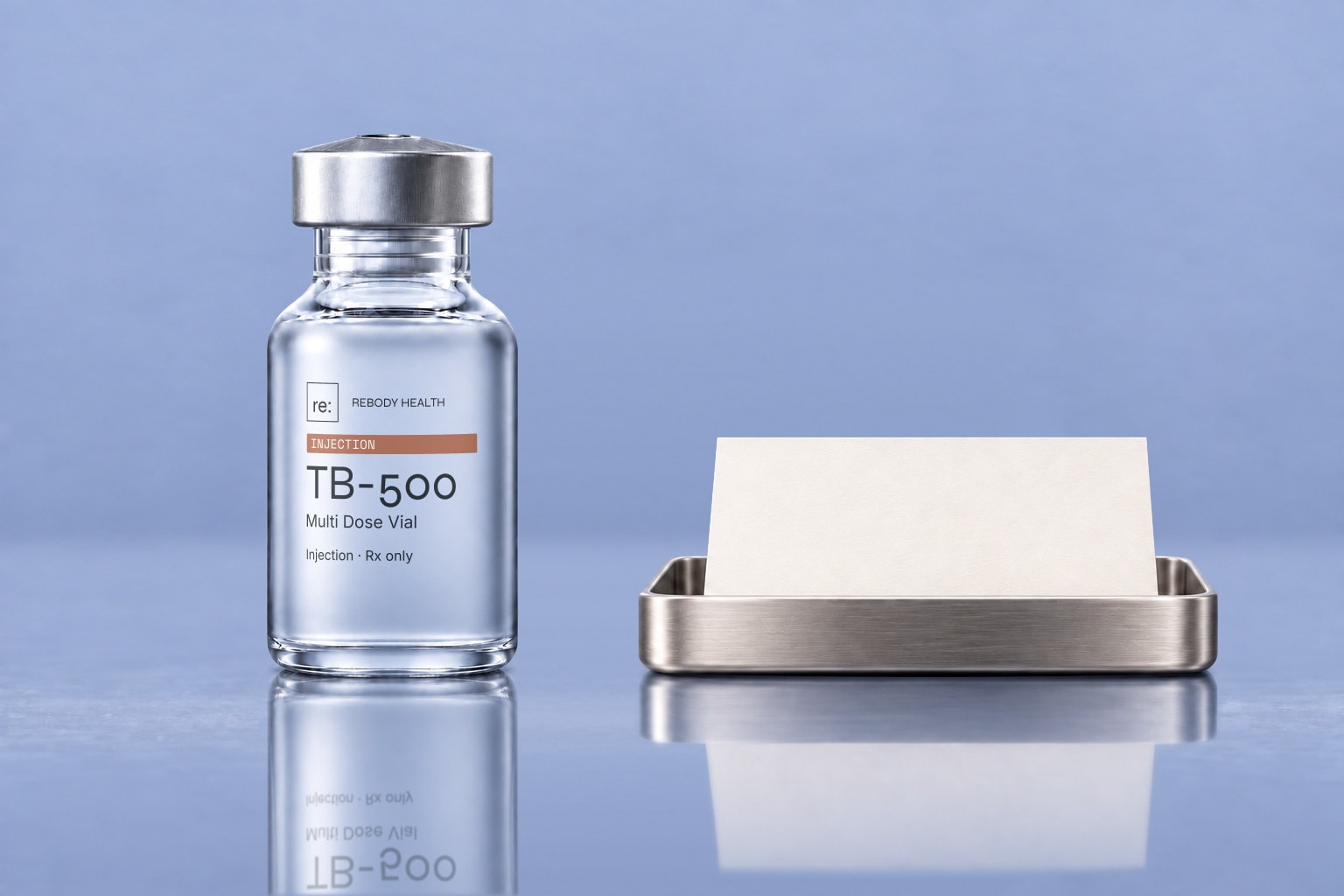 Frosted Rebody TB-500 vial beside a blank planning card on a glossy slate-blue surface.