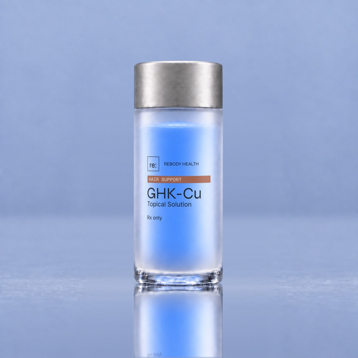 Rebody GHK-Cu blue topical solution in a frosted container on a glossy slate-blue surface.