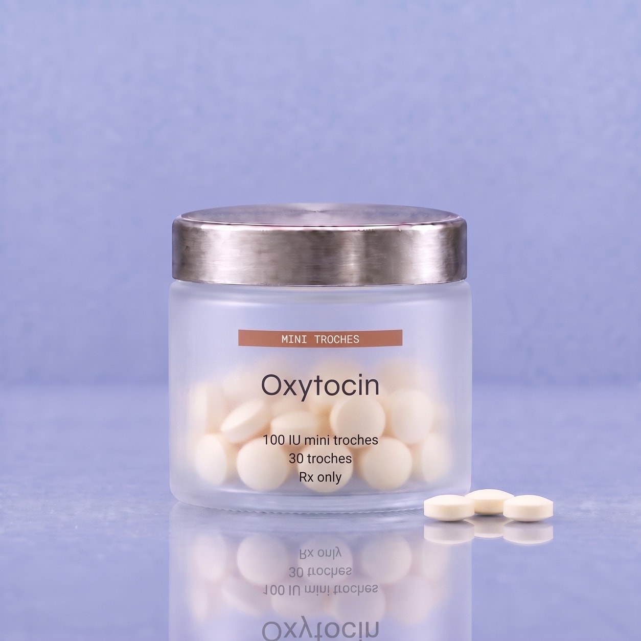 Small ivory oxytocin mini troches in a frosted jar with a brushed silver lid, with three troches beside it.
