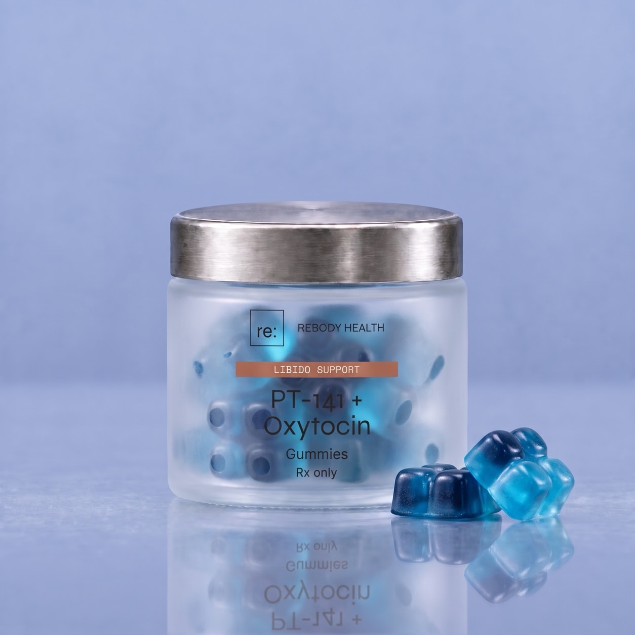 Blue PT-141 + oxytocin gummies, each a square of four small cubes, inside a wide frosted jar with a silver lid.