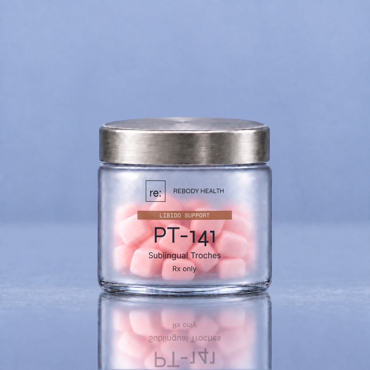 Rebody PT-141 mini troches in a wide frosted jar on a glossy slate-blue surface.