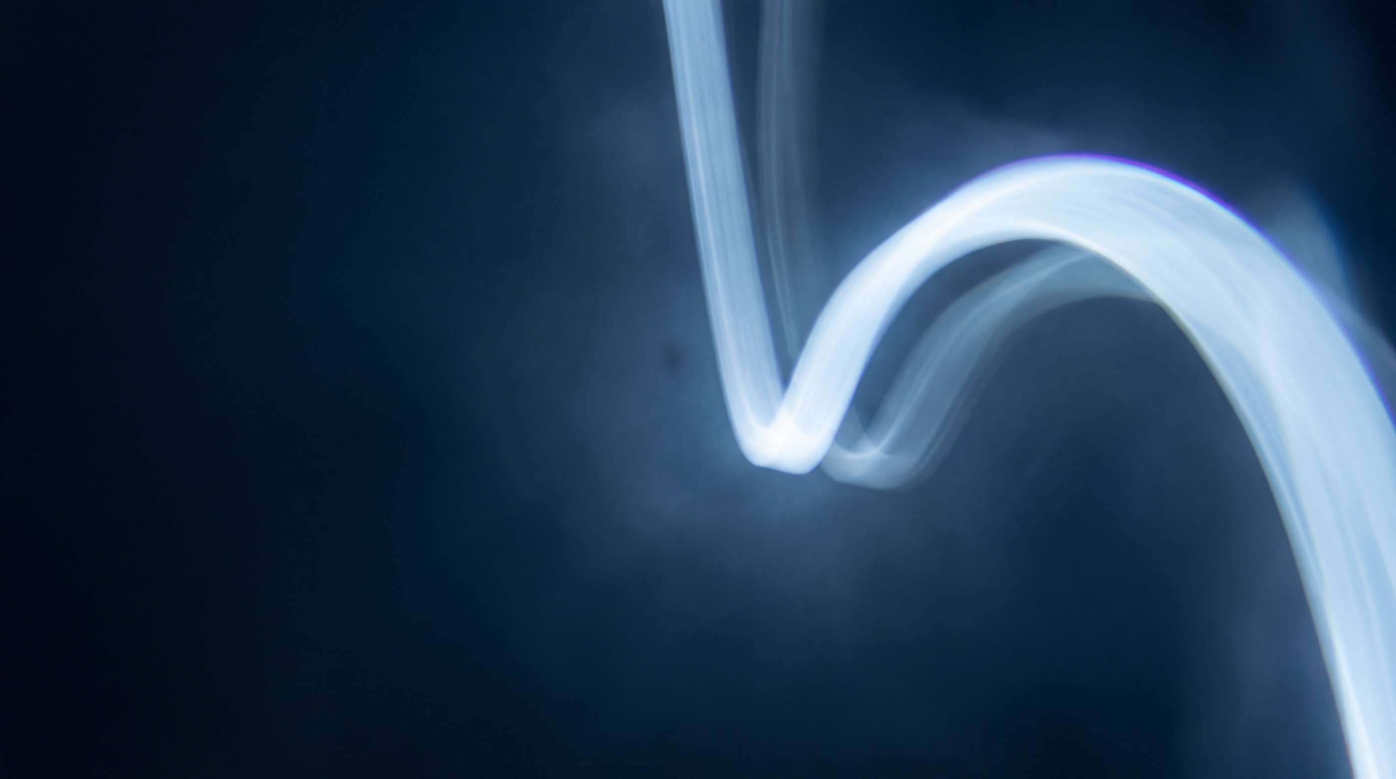 Light moving across a dark surface in slow, deep waves.